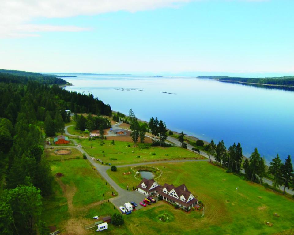 an aerial view of a house next to a lake at Two Eagles Lodge in Union Bay