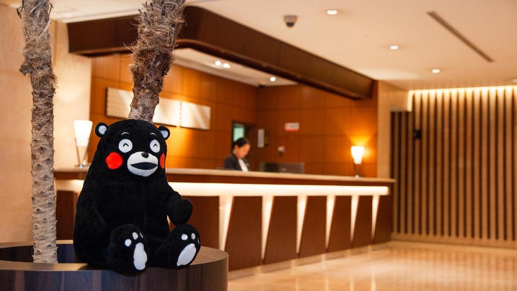a stuffed panda bear sitting next to a bar at Mitsui Garden Hotel Kumamoto in Kumamoto