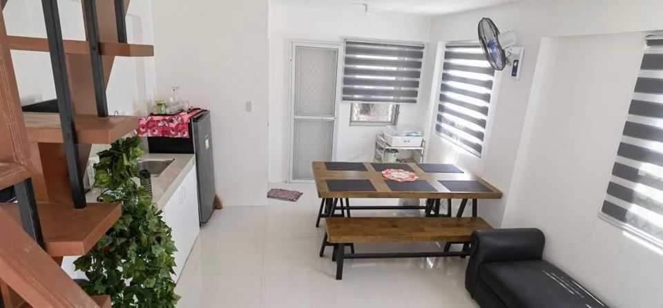 a small dining room with a table and chairs at Camella Staycation in Butuan