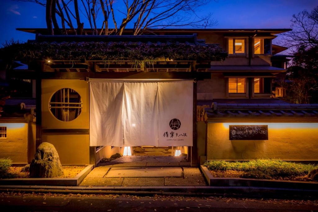 Hotel Yuraku Kyo-yasaka في Giommachi: منزل أمامه ستارة بيضاء