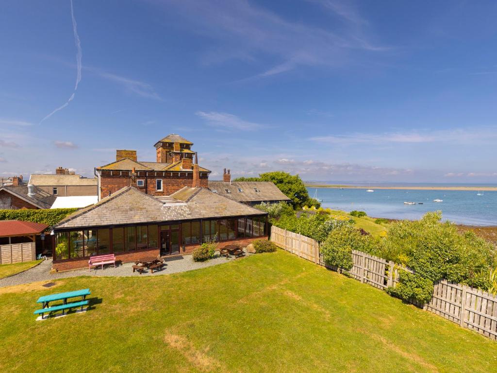 an aerial view of a large house with a yard at Roa Island House in Rampside