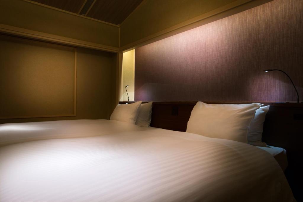 Hotel Yuraku Kyo-yasakaにあるベッド