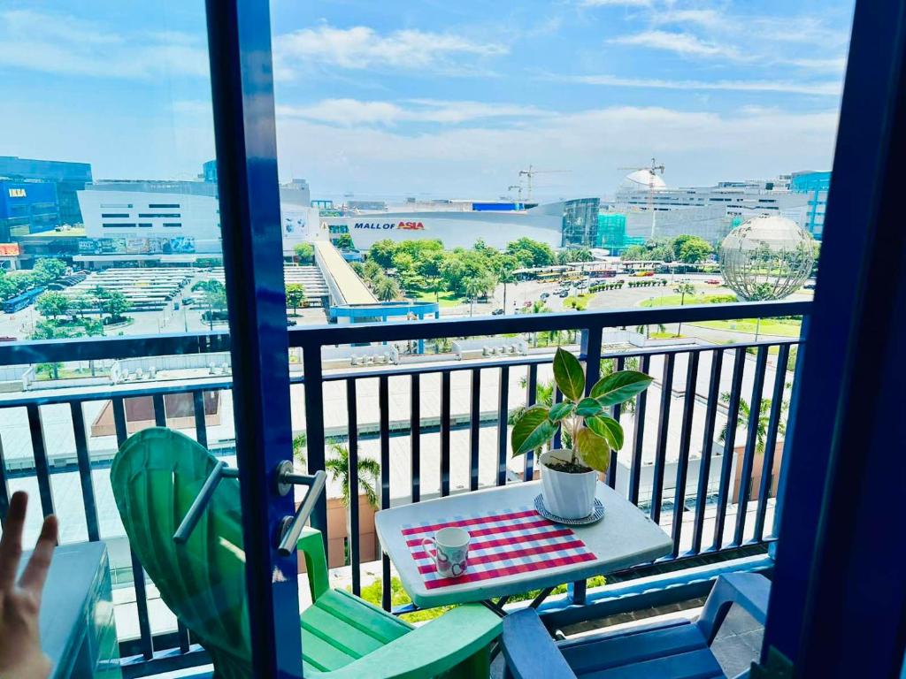 a balcony with a table and a view of a city at Sea Residences - Property Val Alano 0995-448-8872 in Manila