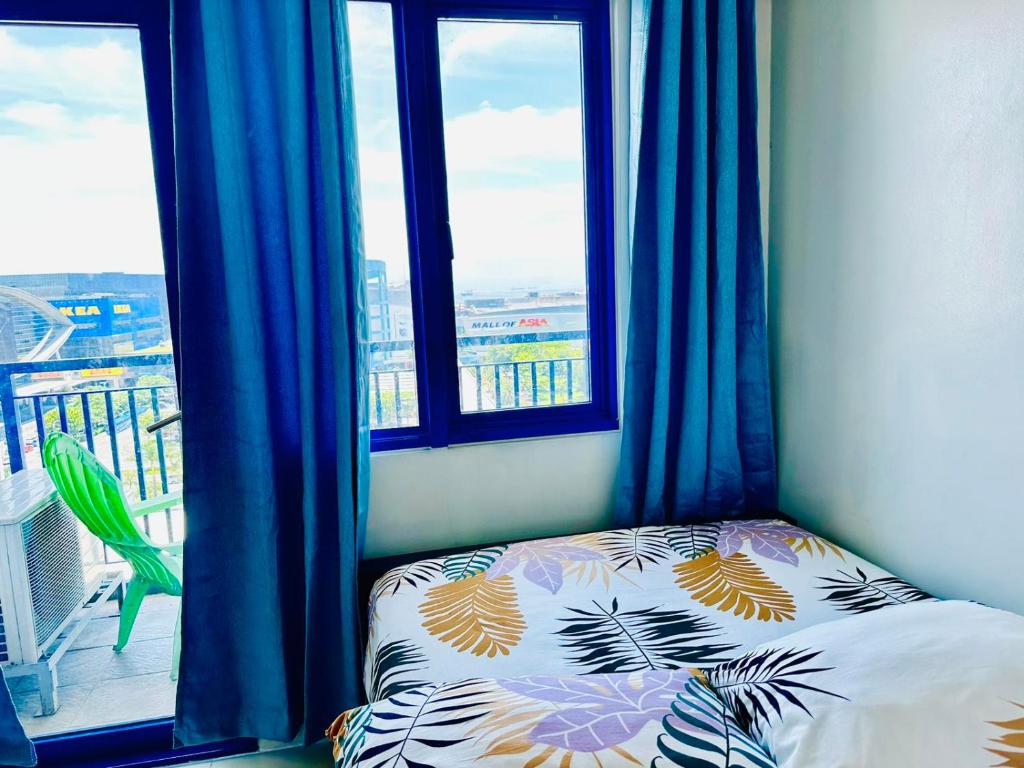 a bedroom with a bed in front of a window at Sea Residences - Property Val Alano 0995-448-8872 in Manila