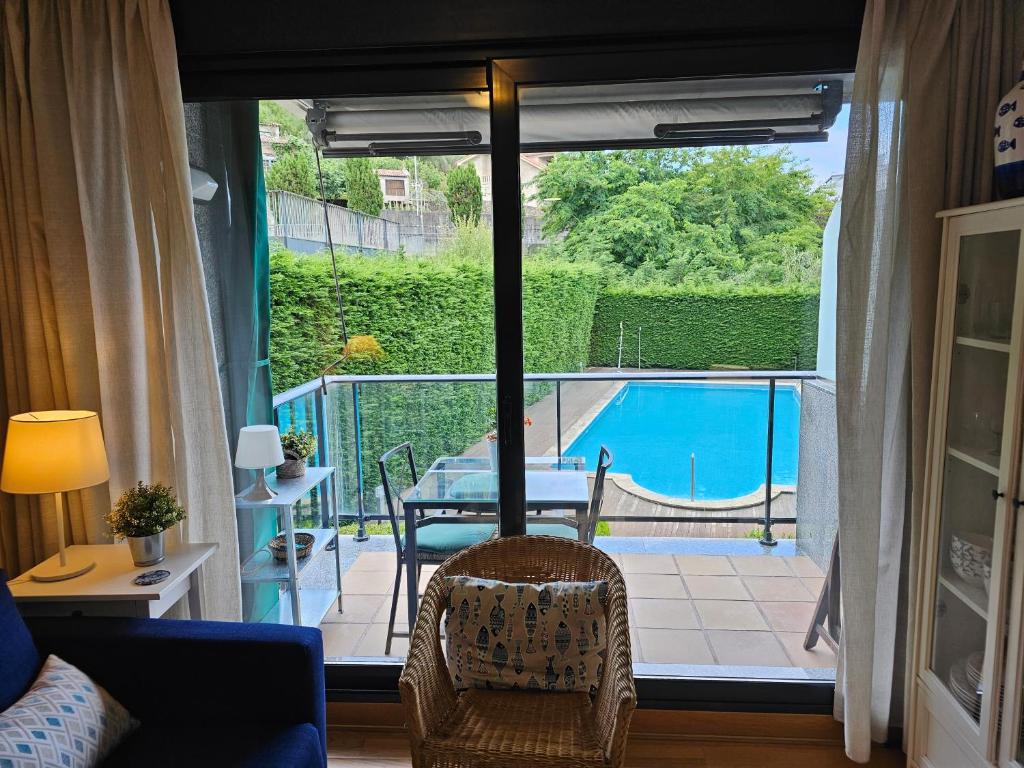 a living room with a view of a swimming pool at Ladeira in Baiona