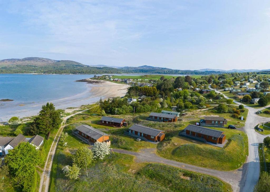 an aerial view of a resort next to a beach at Sandgreen Caravan Park in Girthon