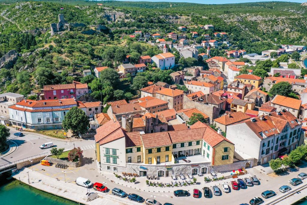 an aerial view of a town next to the water at Hotel Kanjon Zrmanje in Obrovac