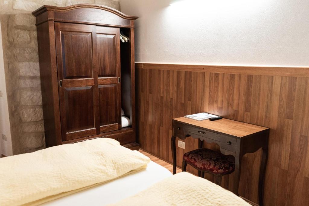 Postel nebo postele na pokoji v ubytování Albergo Garni Orchidea