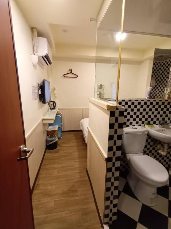 a bathroom with a toilet and a sink at Galaxy Mini Inn in Taipei