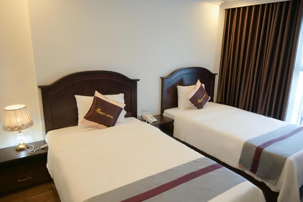 Postel nebo postele na pokoji v ubytování Mercy Hotel