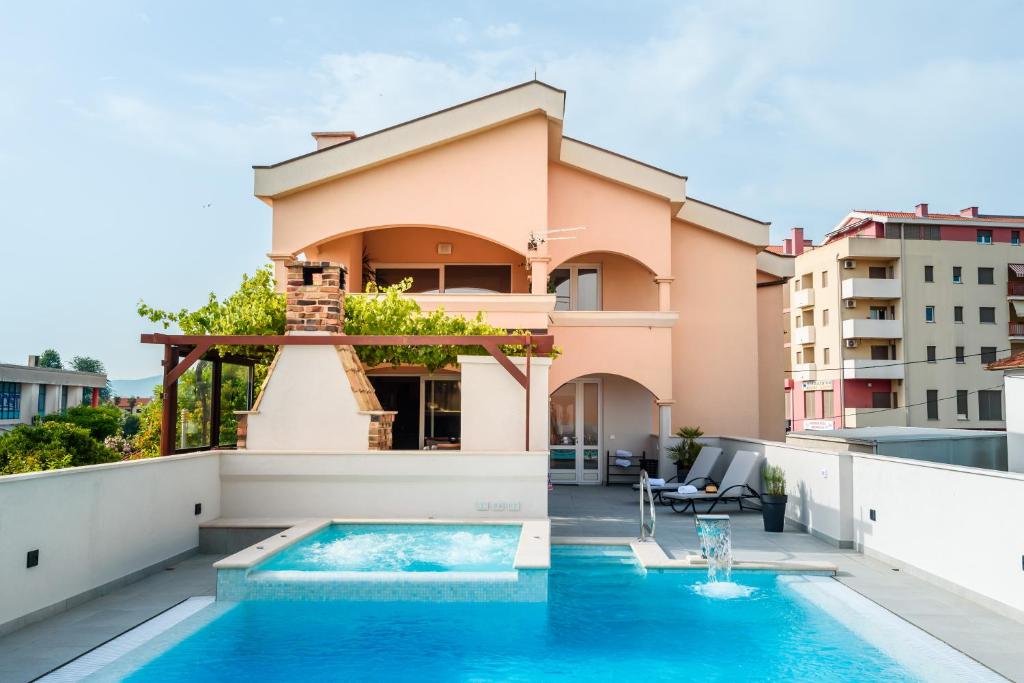 a house with a swimming pool on a balcony at Neretva Valley Apartments - Heated Pool in Metković