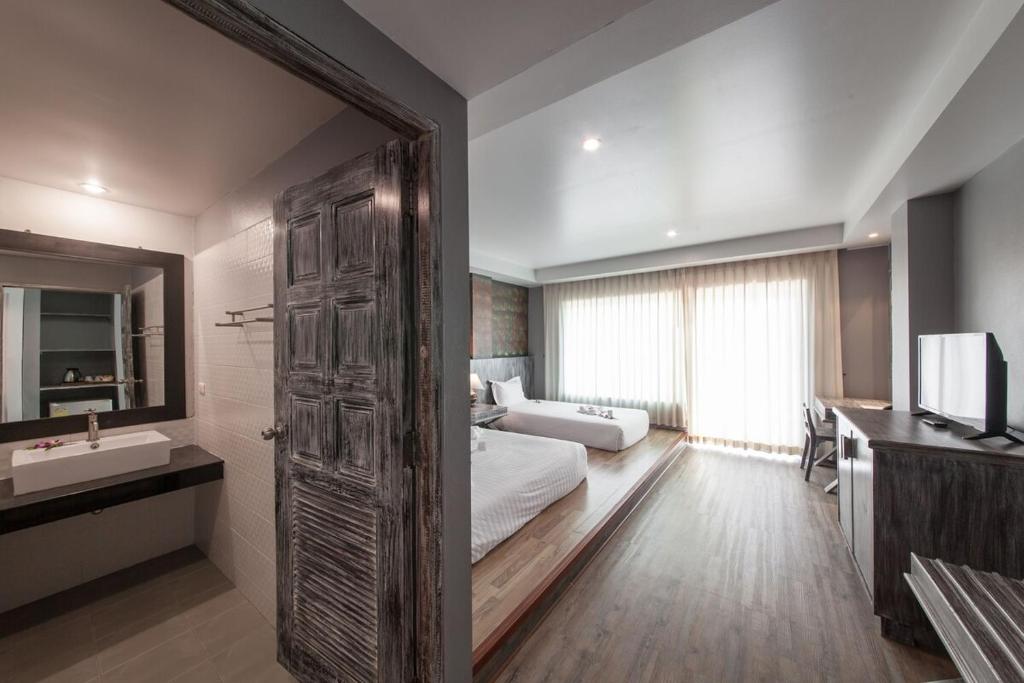 Postel nebo postele na pokoji v ubytování JALMIN Hotel Samui