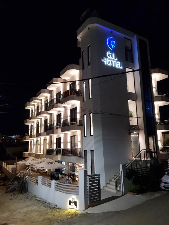 a hotel with a sign on the side of it at GL Hotel Ksamil in Ksamil