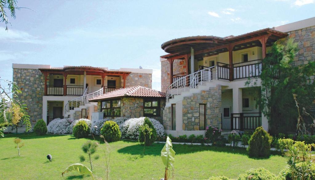 a large house with a lawn in front of it at Villanaz Apart Hotel in Bitez