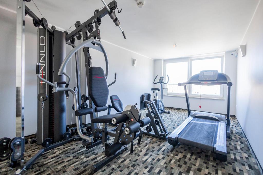 een fitnessruimte met loopbanden en een loopband bij Al-Dom Apartamenty, Apartament SUN w Welle z dostępem do sauny i jacuzzi in Grzybowo