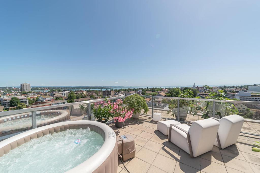 a hot tub on the roof of a building at City Dream Seeblick free parking in Kreuzlingen