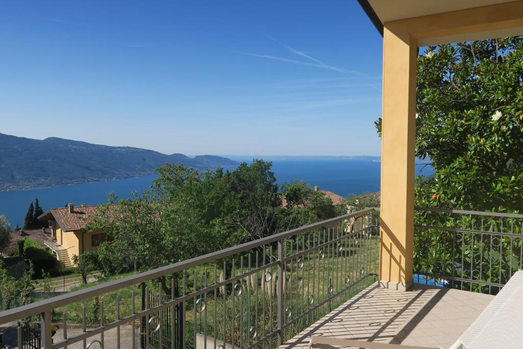a balcony with a view of the water at Villa Arianna - Apartments with lake view, pool, garten, privacy, parking, close to city center in Tignale