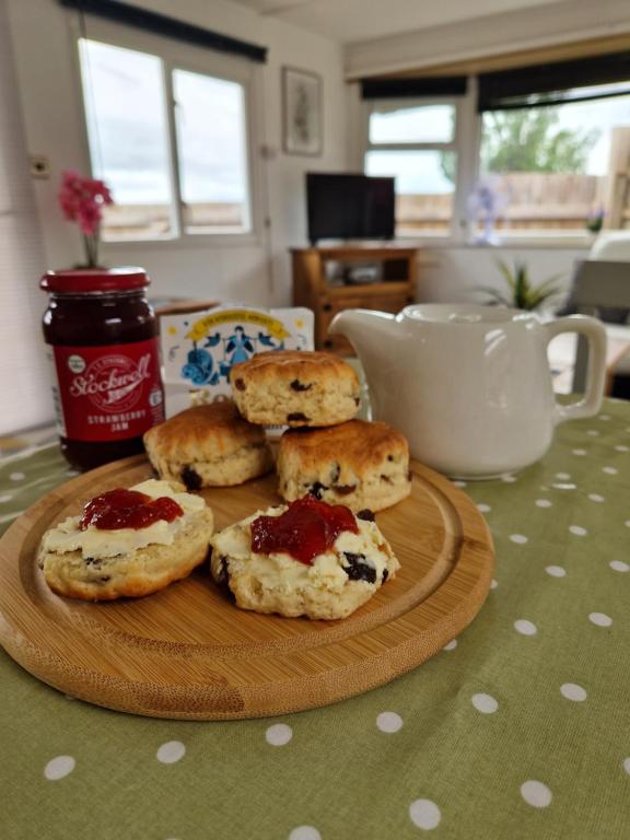 a plate of biscuits with jam on a table at Featheredge Lodge, UK in Wells