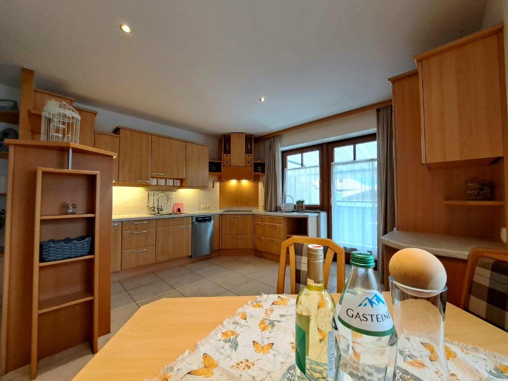 a kitchen with a table with a bottle of water on it at Appartement Stadler in Bad Hofgastein