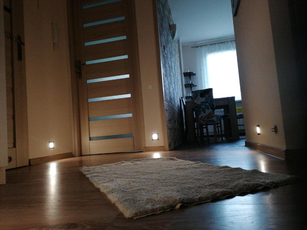 a room with a door and a rug on the floor at Mieszkanie 50M in Rymanów-Zdrój