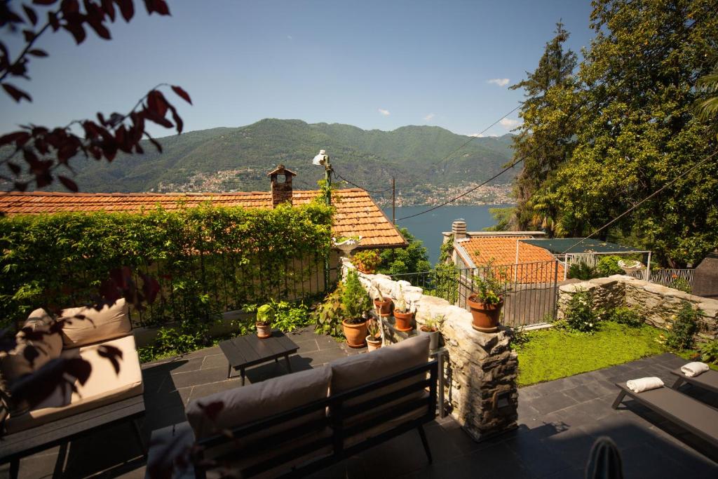 a house with a patio with a view of the water at Pietralago, Casa con vista sul Lago in Blevio