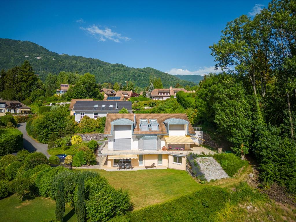 an aerial view of a house with a yard at Blonay Garden Apartment - Swiss Hotel Apartments in Blonay
