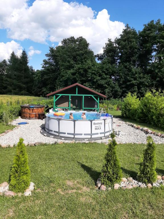 a boat in a yard with two people in it at Odsapka u Agi in Wydminy