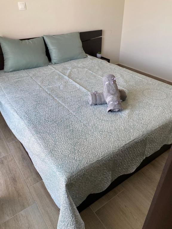 a stuffed animal sitting on top of a bed at Anastasia Apartment in Kalivia Poligirou