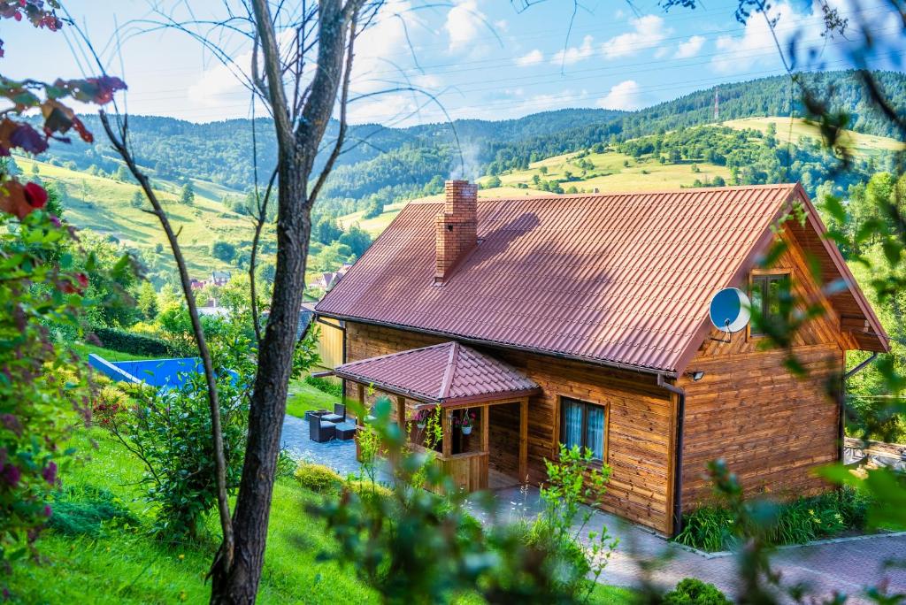 ピブニチュナ・ズドルイにあるDomek Góralskiの赤い屋根の小さな木造家屋