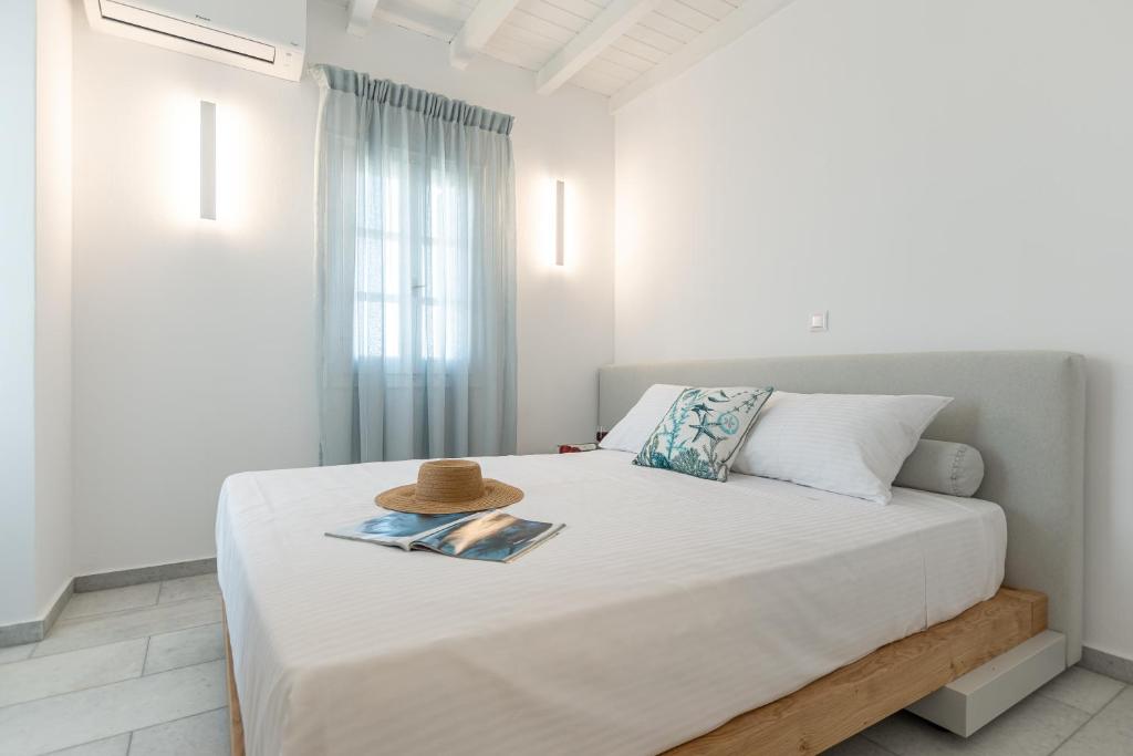 a bedroom with a bed with a hat on it at Caruana Inland Naxos in Agia Anna Naxos