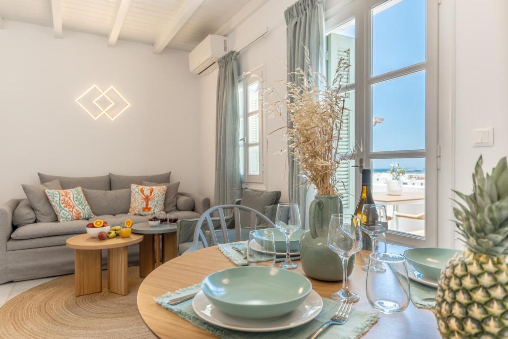 a living room with a table and a couch at Caruana Living in Agia Anna Naxos