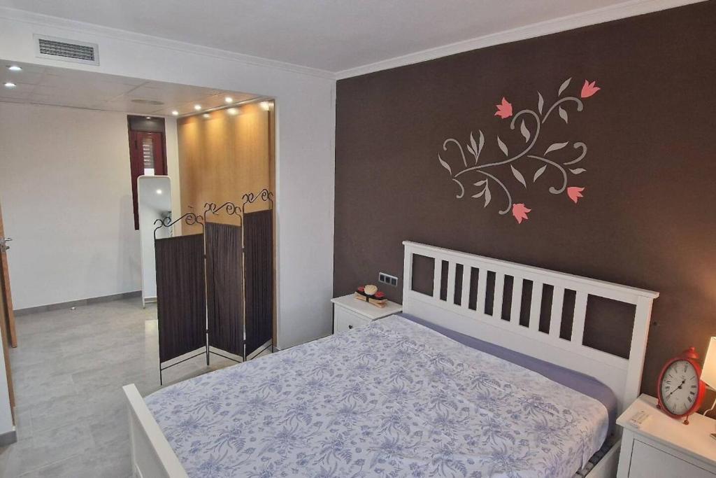 1 dormitorio con cama y pared con pegatina de árbol en Casa Cani en Villareal