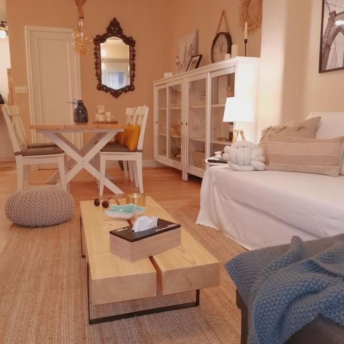 a living room with a bed and a table at Rías Baixas. Acogedor piso en la Ría de Arousa in Ribeira