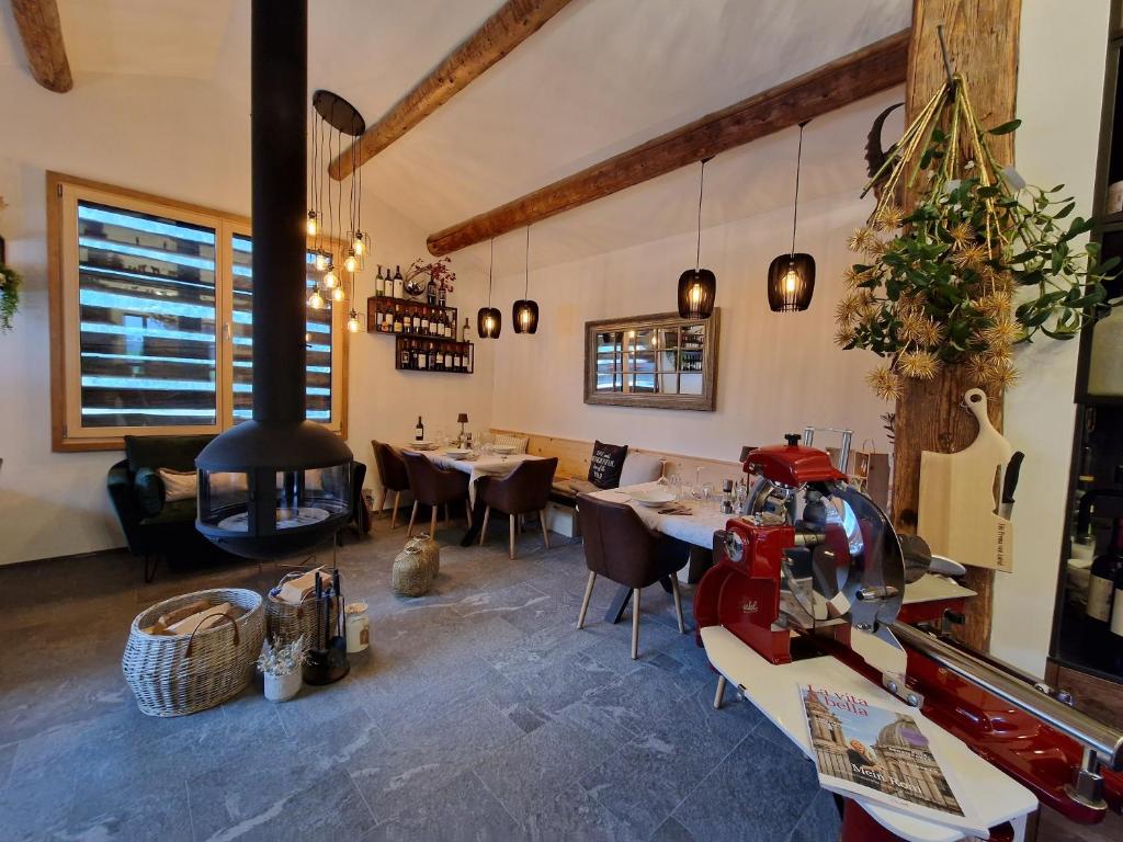 a restaurant with a stove in the middle of a room at Chesa Prema Bed & Breakfast - Restaurant in Disentis