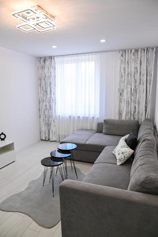 a living room with a couch and a table at Acasă la Maria in Petrila