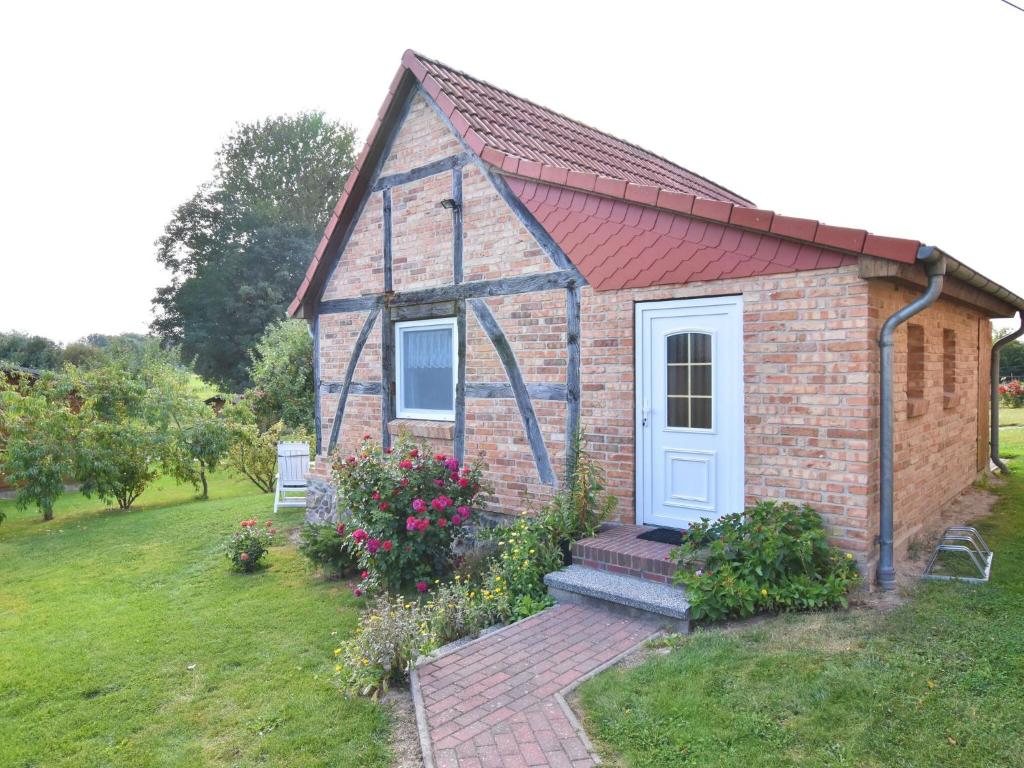 a brick house with a blue door in a yard at Modern Apartment in Elmenhorst near Sea in Elmenhorst