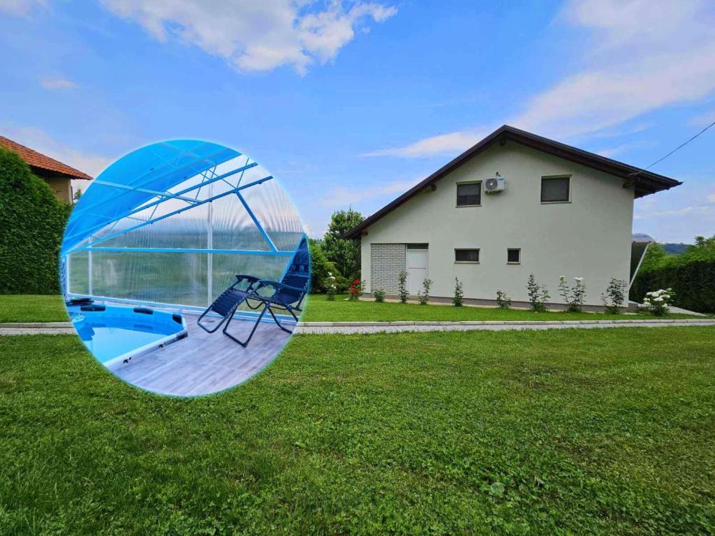 a glass orb in the grass in front of a house at Guest house Al Meri in Travnik