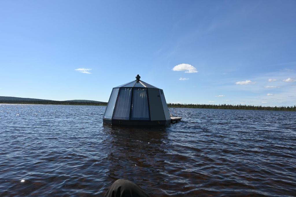 a small boat in the middle of a lake at Laponia Sky Hut in Gällivare