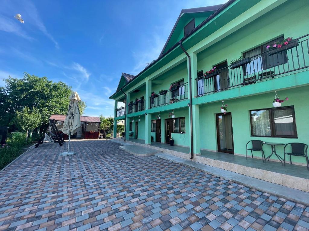 a building with a cobblestone street in front of it at SunRise in Corbu