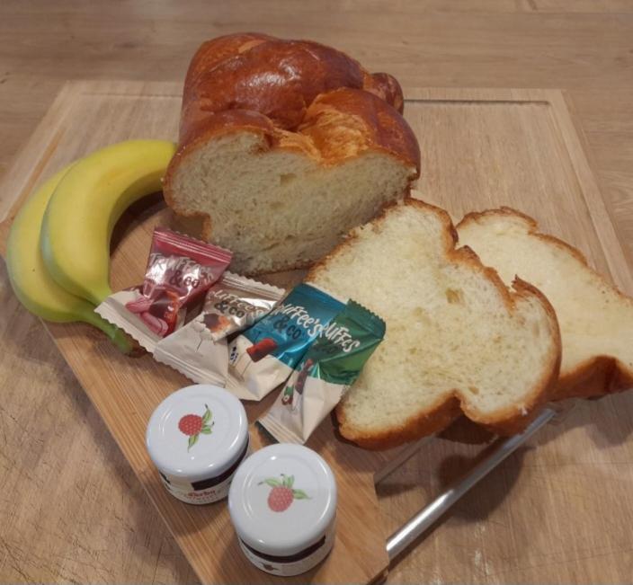 a cutting board with a loaf of bread and a banana at instant à deux in Précigné
