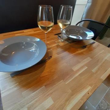 a wooden table with two glasses of wine on it at instant à deux in Précigné