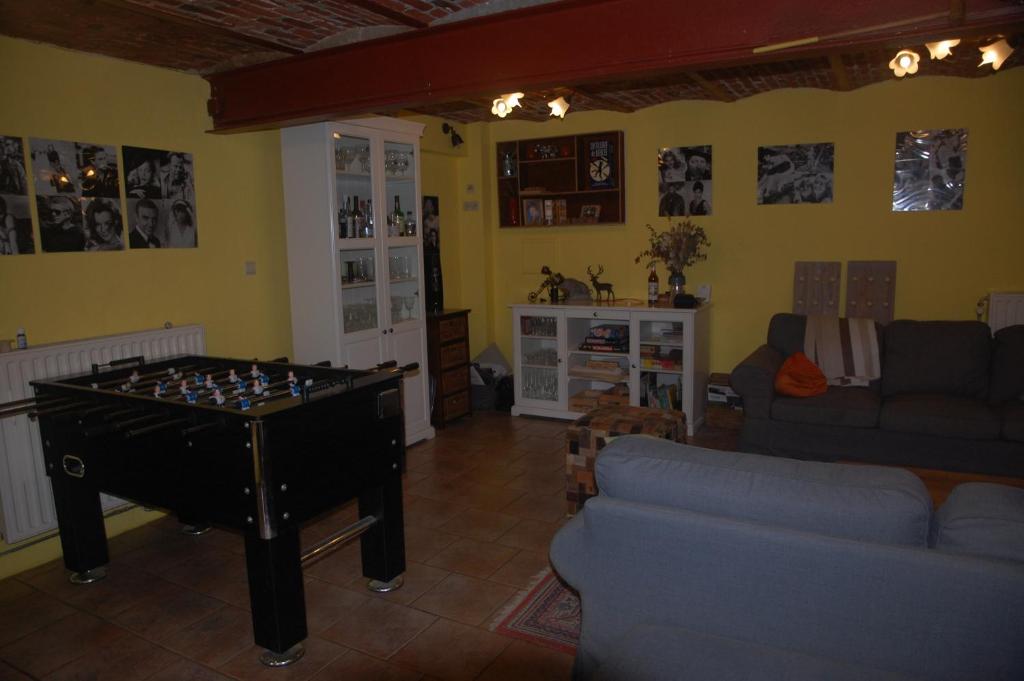 a living room with a foosball table in the middle of a room at Le Buisson B&amp;B in Gouvy