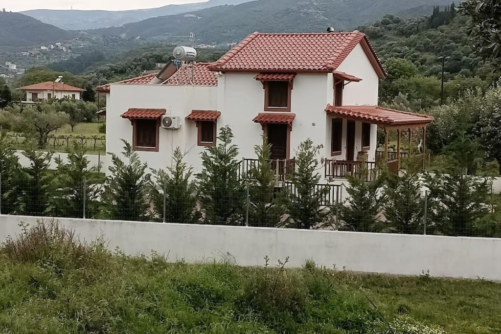 a white house with a fence in front of it at Αναστασία 