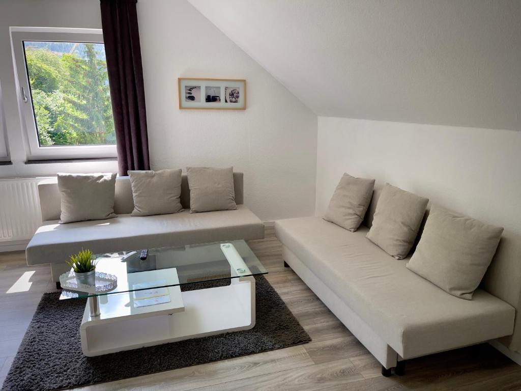 a living room with a couch and a coffee table at Ferienwohnung am Wald in Haiterbach