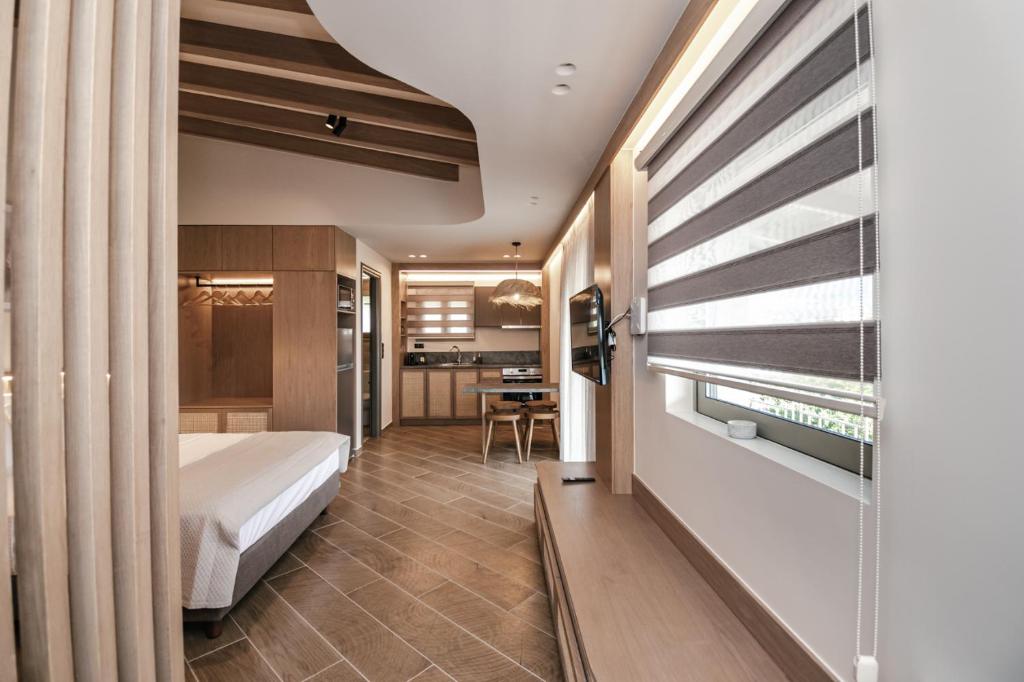Postel nebo postele na pokoji v ubytování Terra Hélios Suites & Studios