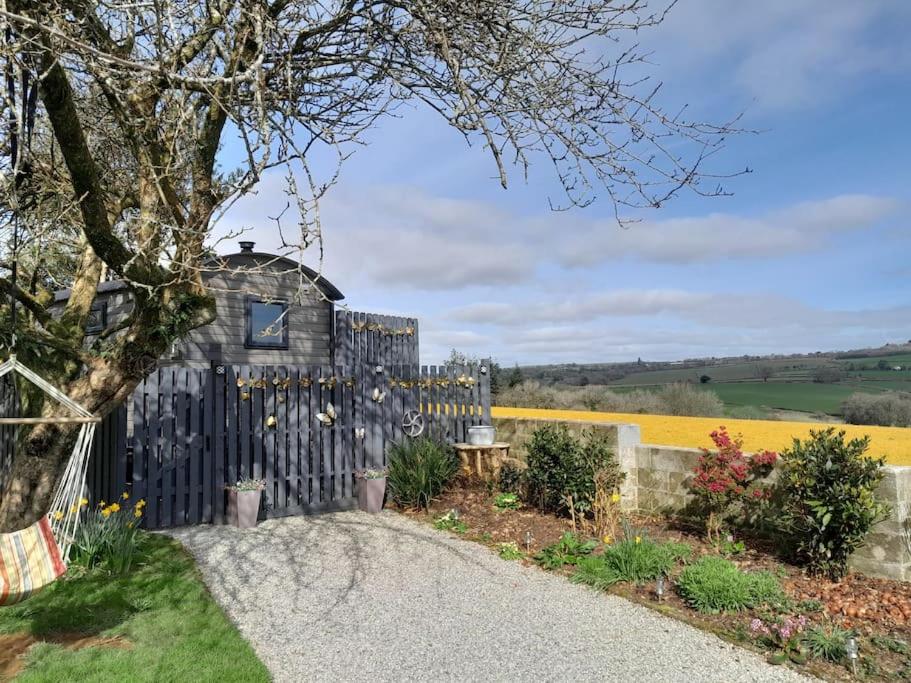 a black fence with a table in a garden at Hillview Haven at Hillcrest in Liskeard