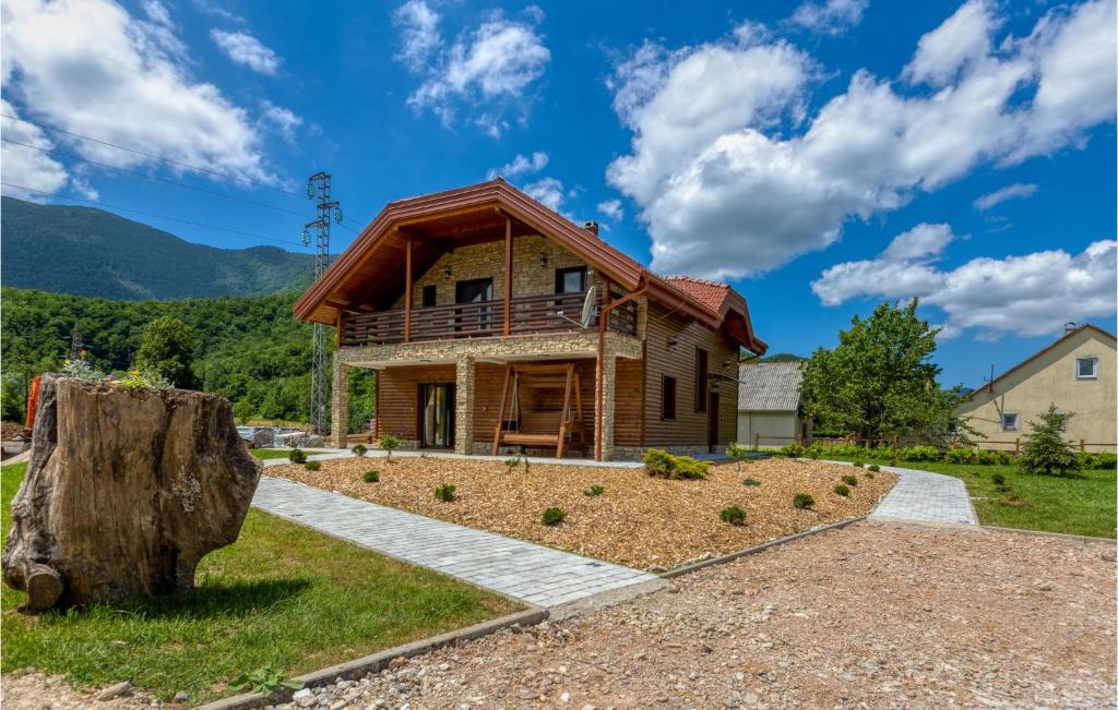 a house on a hill with a tree stump at 3 Bedroom Nice Home In Brusane in Brušane