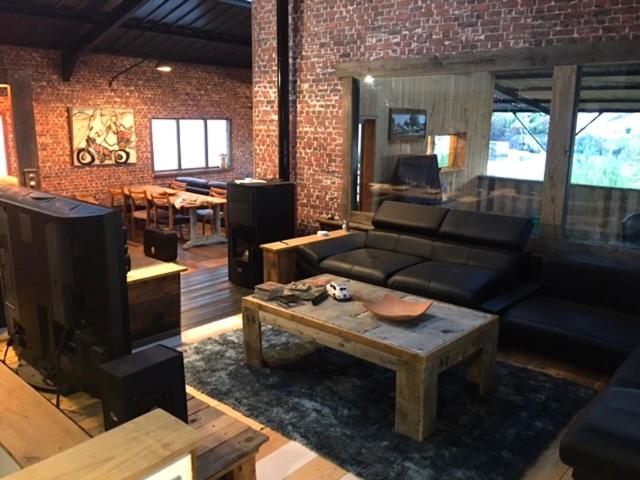 a living room with a couch and a coffee table at Magnifique loft atypique proche gare et bord de rivière in Le Mans