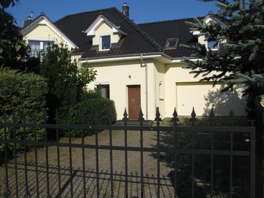 una casa blanca con una valla delante en Spacious Family House/ 5 bedrooms/ 12km to Opole 