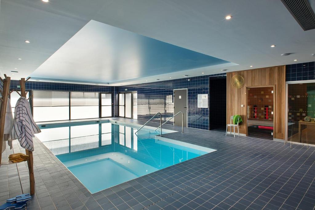 a large swimming pool in a building at DOMITYS LA CALYPSO in Brest